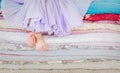 The fairy tale the princess on a pea. Little girl in lilac tatu skirt sitting on the high bed. Bare foot if the girl Royalty Free Stock Photo