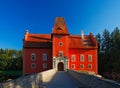 Fairy tale red castle on the lake with bridge, with dark blue sky, state castle Cervena Lhota, Czech republic Royalty Free Stock Photo