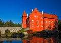 Fairy tale red castle on the lake, with dark blue sky, state castle Cervena Lhota, Czech republic Royalty Free Stock Photo