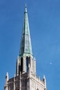 Fairy tale spire of Tulsa with copper roof and half moon in sky