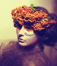 Fairy tale. Woman in wreath of rowan berry