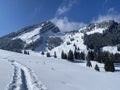 Fairytale alpine winter atmosphere and snow-capped alpine peaks Stockberg 1781 m and Chli Stockberg 1597 m in the Alpstein