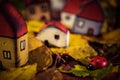 Fairytale dwarf houses and a ladybug in autumn forest. Handmade