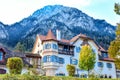 Fairytale house with a balcony on a background of a high mountain in autumn in Alps Royalty Free Stock Photo