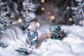 A fairytale rat in a fur coat carries a Christmas tree from a magical fairytale forest lit by lanterns. Royalty Free Stock Photo