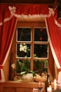 Fairytale window with red curtains Royalty Free Stock Photo