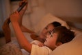 Fairytales gone digital. A mother reading a bedtime story to her son from a digital tablet. Royalty Free Stock Photo