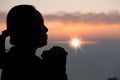 Faith of christian concept. Spiritual prayer hands over sun shine with blurred beautiful sunset background. Female hands worship Royalty Free Stock Photo