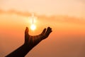 Faith of christian concept. Spiritual prayer hands over sun shine with blurred beautiful sunset background. Female hands worship Royalty Free Stock Photo