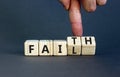 Faith instead fail symbol. Businessman turns wooden cubes and changes the concept word Fail to Faith. Beautiful grey table grey Royalty Free Stock Photo