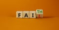 Faith instead fail symbol. Turned a wooden cube and changed the word fail to faith. Beautiful orange table, orange background. Royalty Free Stock Photo