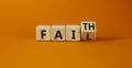 Faith instead fail symbol. Turned a wooden cube and changed the word fail to faith. Beautiful orange table, orange background. Royalty Free Stock Photo