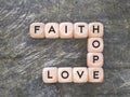 Faith hope love text on wooden cubes with vintage background. Royalty Free Stock Photo