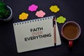 Faith Over Everything write on a book on office desk. Christian faith concept