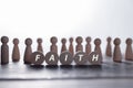 Faith symbol. Turned wooden cube with words Faith. Beautiful white background. Business and Faith concept. Copy space