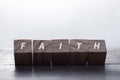 Faith symbol. Turned wooden cube with words Faith. Beautiful white background. Business and Faith concept. Copy space