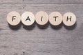 Faith symbol. Turned wooden cube with words Faith. Beautiful wooden table background. Business and Faith concept. Copy space