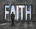 Faith word on concrete wall with man walking toward