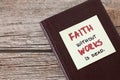 Faith without works is dead, a handwritten quote on a note on top of a closed Christian Holy Bible Book