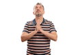 Faithful adult male making praying gesture looking above