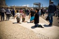 Faithful advancing on their knees in the square of the Sanctuary of Fatima, Portugal