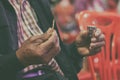 Faithful Asian Elder Praying in the Holy Communion and Praise Jesus