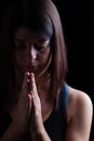 Faithful athletic woman praying, with hands folded in worship to god Royalty Free Stock Photo