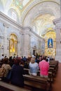 Faithful praying in the interior of the Sanctuary of Sao Bento da Porta Aberta Royalty Free Stock Photo