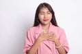 Faithful woman closes eyes and keeps hands on chest near heart, shows her kindness Royalty Free Stock Photo