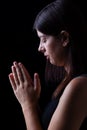 Faithful woman praying, with hands folded in worship to god Royalty Free Stock Photo