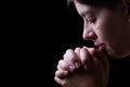 Faithful woman praying, hands folded in worship to god Royalty Free Stock Photo