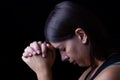 Faithful woman praying, hands folded in worship to god Royalty Free Stock Photo