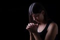 Faithful woman praying, hands folded in worship to god Royalty Free Stock Photo