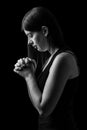 Faithful woman praying, hands folded in worship to god Royalty Free Stock Photo