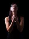 Faithful woman praying, hands folded in worship to god with looking up Royalty Free Stock Photo