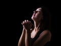 Faithful woman praying, hands folded in worship to god with looking up Royalty Free Stock Photo