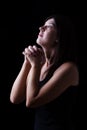 Faithful woman praying in worship to god looking up in hope