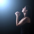 Faithful woman praying in worship to god looking up in hope