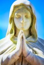 Faithfull Virgin Mary with praying hands and blessing, looking at the sky