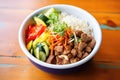 fajita bowl with rice, beans, meat, and vegetables