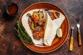 Fajitas Tortilla wraps with beef meat steak stripes, sweet pepper and onions. Dark Wooden background. Top view Royalty Free Stock Photo