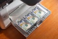 Fake American money dollars printed on a printer. The concept of stopping forgeries, printing money Royalty Free Stock Photo