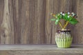 Fake flowers in a vase placed on a table on a wooden table with copy space for design wood grain vintage background Royalty Free Stock Photo