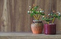 Fake flowers in a vase placed on a table on a wooden table with copy space for design wood grain vintage background Royalty Free Stock Photo