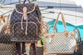 Fake high-end famous designer purses and backpacks for sale at a local outdoor flea market in Ventimiglia, Italy