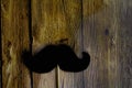 Fake moustache on a wooden background.. Photo props mustaches. men day, Birthday and Party Set and wedding. Flat lay, top view, co