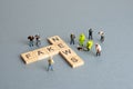 Fake news concept - figurines investigating scrabble pieces Royalty Free Stock Photo