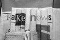 Fake news on newspapers black and white background