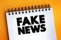 Fake News text on notepad, concept background Royalty Free Stock Photo