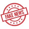 FAKE NEWS text written on red vintage round stamp Royalty Free Stock Photo